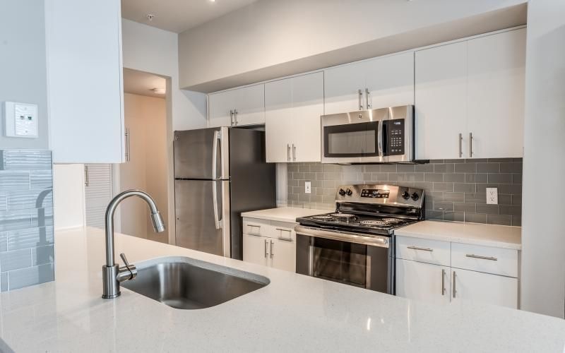 a kitchen with white cabinets