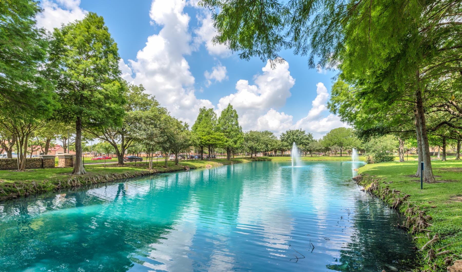 a pond with a fountain in it