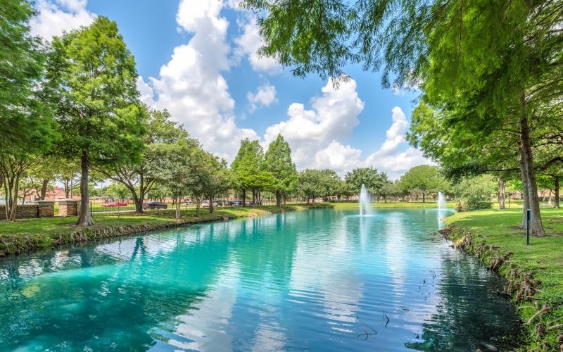 a pond with a fountain in it